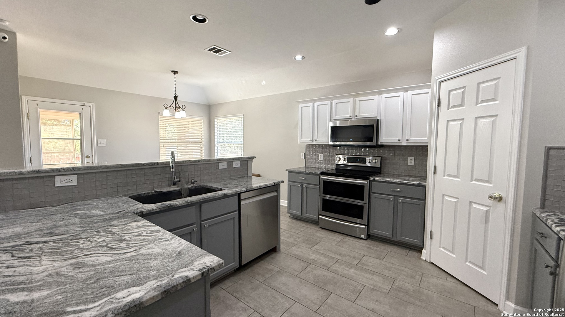 9402 Anderson Way Converse, TX 78109 - Photo 8 of 37 a kitchen with stainless steel appliances granite countertop a stove and a sink