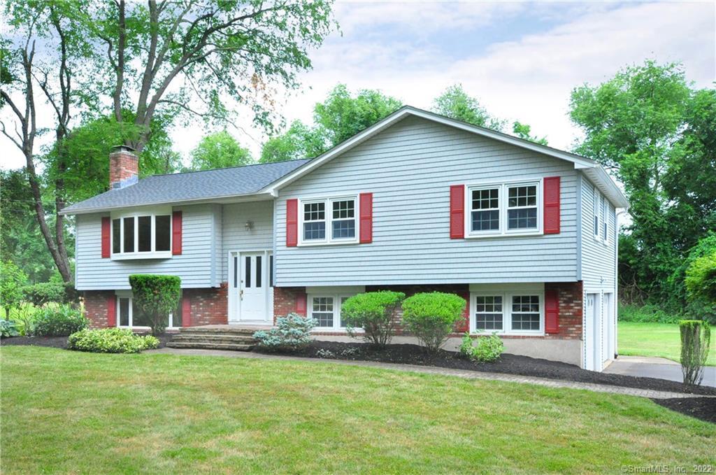 a front view of a house with a garden and porch