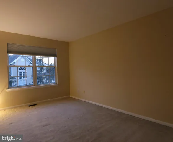an empty room with a empty space and windows