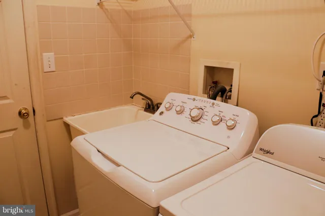 a white bath tub sitting next to a white toilet