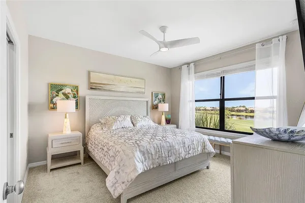 a bedroom with a bed and a large window