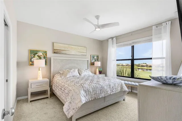 a bedroom with a bed and a large window