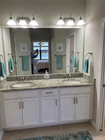 a bathroom with sinks granite and a mirror