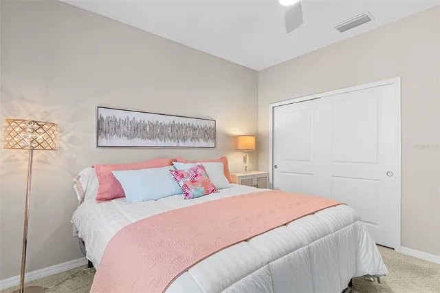 a bedroom with a bed and a night stand