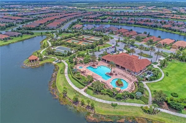 an aerial view of residential houses with outdoor space and street view