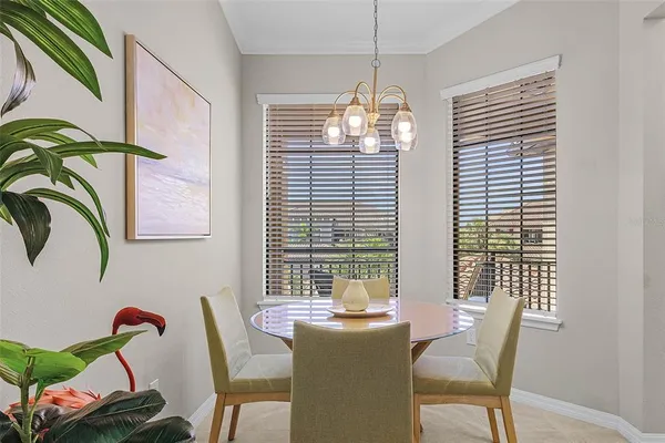 a view of a dining room with furniture wooden floor and chandelier