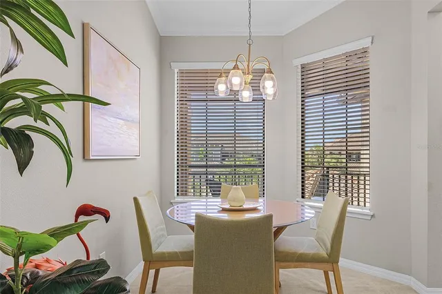 a view of a dining room with furniture wooden floor and chandelier