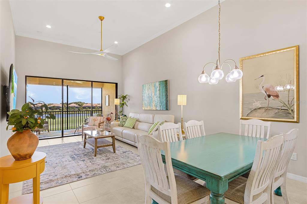 13725 Messina Loop, Unit 201 Bradenton, FL 34211 - Photo 10 of 39 a living room with furniture a chandelier and a large window