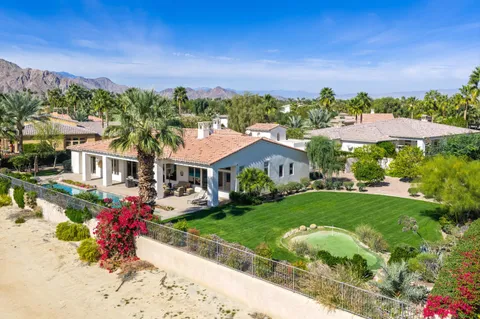 a living room with fireplace furniture and a chandelier