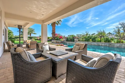 a view of a house with a yard and sitting area
