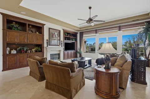 a view of a dining room with furniture and a chandelier