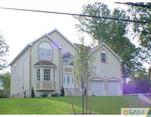 331 Chain O' Hills Road Colonia, NJ 07067 - Photo 2 of 8 a front view of a house with garden