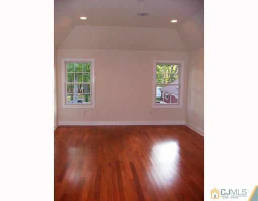 331 Chain O' Hills Road Colonia, NJ 07067 - Photo 3 of 8 a view of an empty room with wooden floor and a window