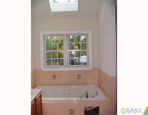 331 Chain O' Hills Road Colonia, NJ 07067 - Photo 4 of 8 a bathroom with a bathtub and a window