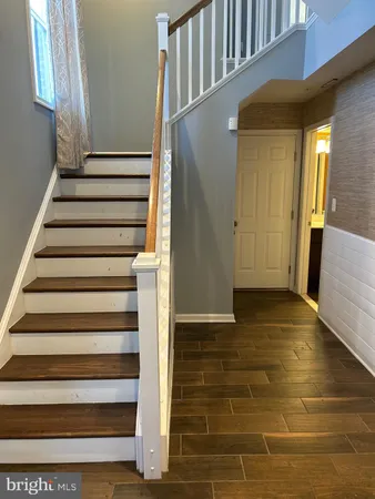 a view of entryway with wooden floor and stairs