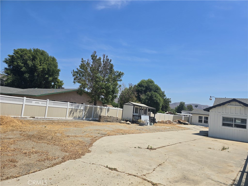 876 River Drive Norco, CA 92860 - Photo 3 of 22 a house with trees in front of it
