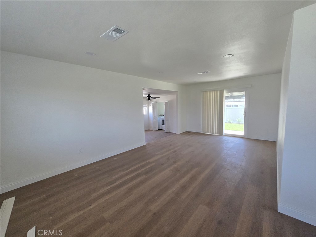 876 River Drive Norco, CA 92860 - Photo 9 of 22 wooden floor in an empty room with a window