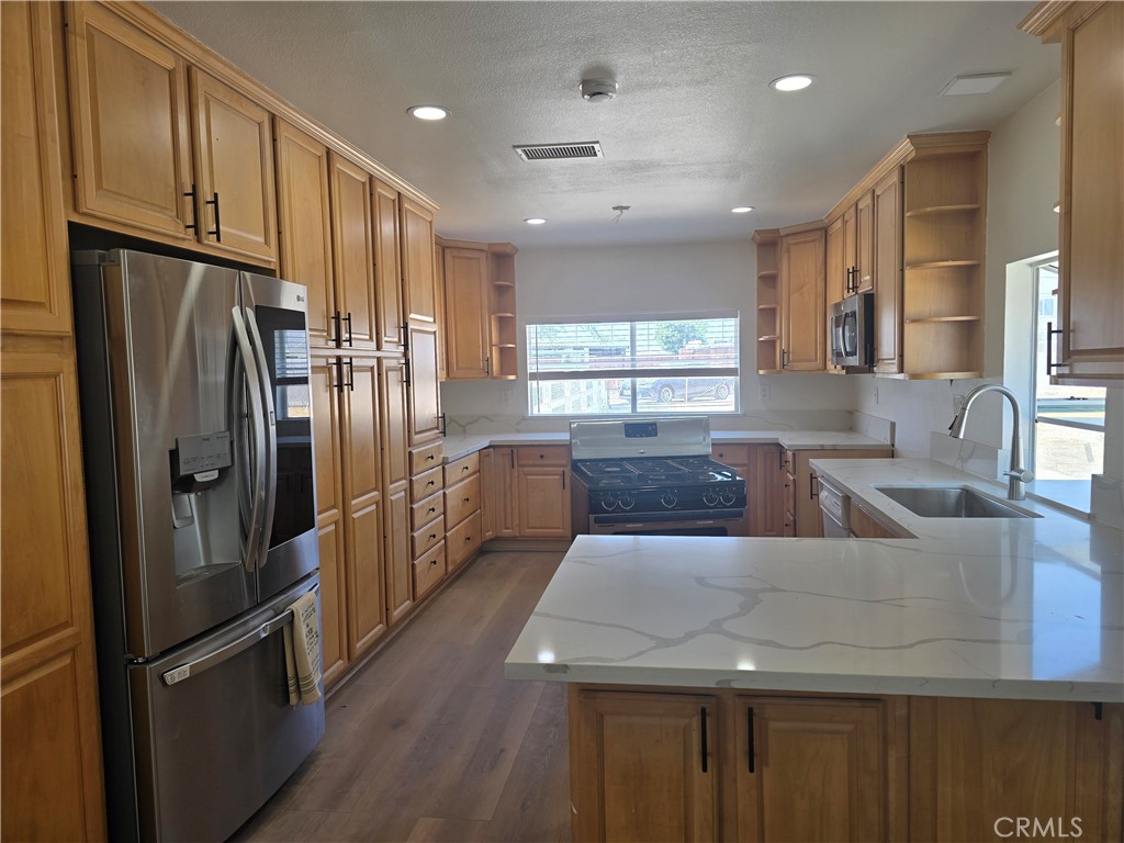 876 River Drive Norco, CA 92860 - Photo 10 of 22 a kitchen with stainless steel appliances granite countertop a refrigerator a sink a stove and a refrigerator
