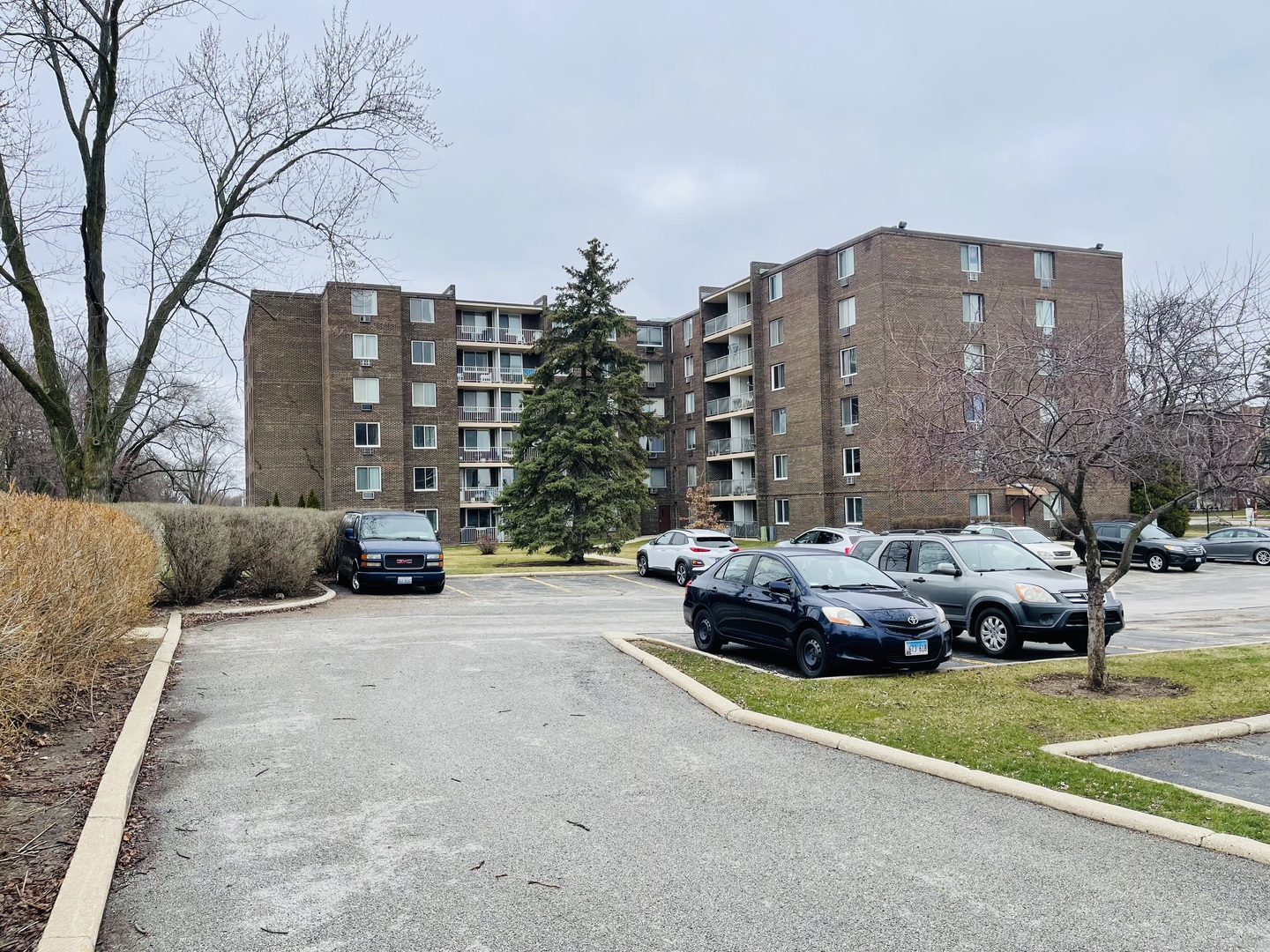 225 South Rohlwing Road, Unit 114 Palatine, IL 60074 - Photo 2 of 18 a front view of a house with a garden and parking