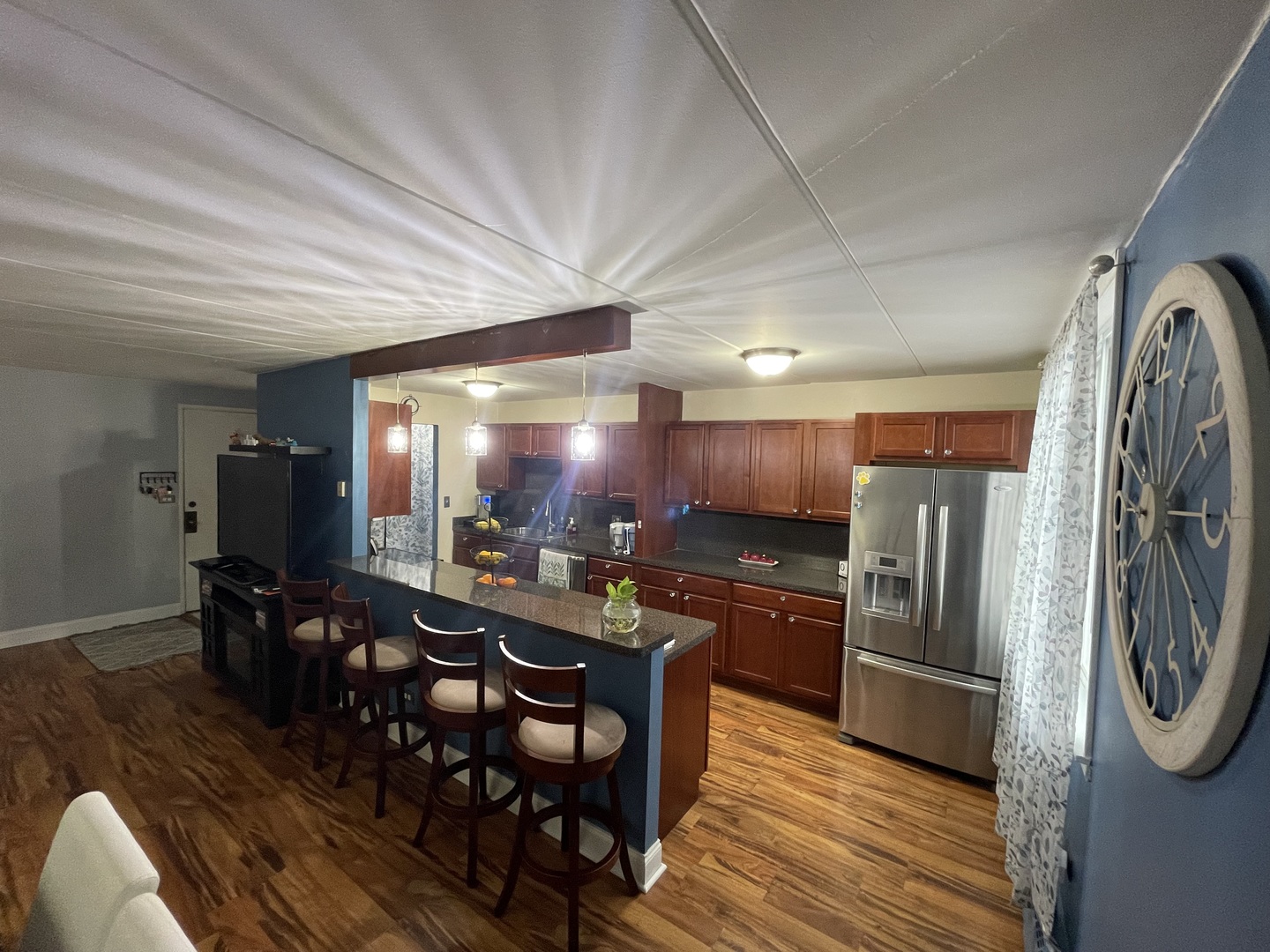 225 South Rohlwing Road, Unit 114 Palatine, IL 60074 - Photo 9 of 18 a kitchen with stainless steel appliances granite countertop a refrigerator a stove a sink a dining table and chairs with wooden floor