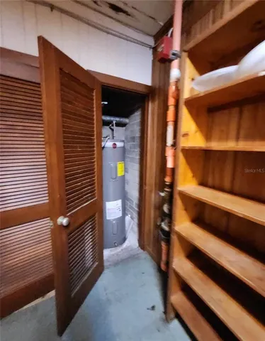 a view of an empty room with stairs and a window