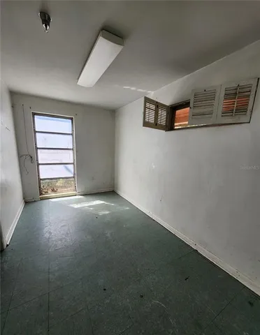 an empty room with a empty space and windows