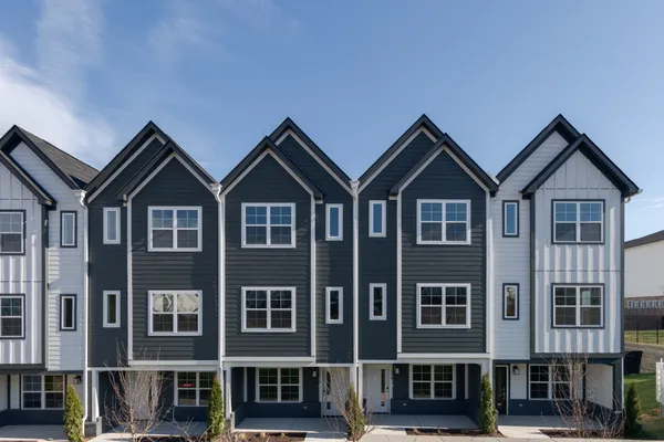 a front view of a residential apartment building with a yard