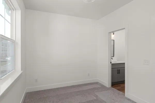 an empty room with windows and entrance
