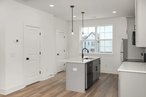 a kitchen with a sink stove and cabinets