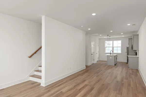 a view of a big room with wooden floor and windows