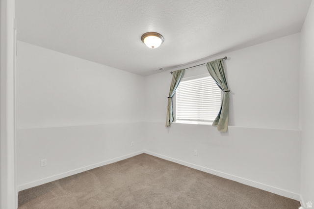 6120 North Sheps Ridge Road Eagle Mountain, UT 84005 - Photo 16 of 43 Room with neutral-toned carpet flooring and white walls
