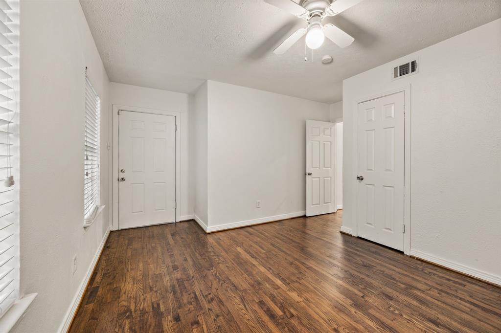 6644 Fisher Road Dallas, TX 75214 - Photo 17 of 21 a view of an empty room with wooden floor and a window