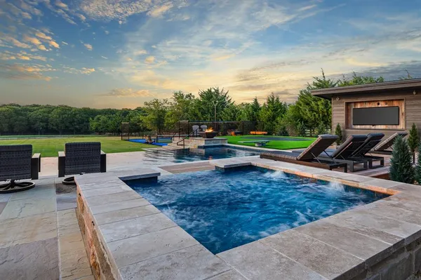 a view of a backyard with sitting area