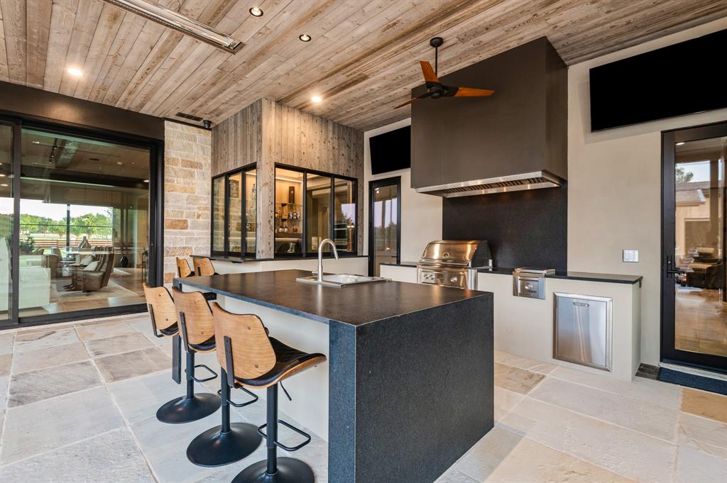 988 English Road Rockwall, TX 75032 - Photo 24 of 40 a dining hall with stainless steel appliances kitchen island granite countertop a table chairs and a refrigerator