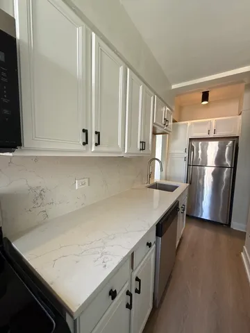 a kitchen with stainless steel appliances a refrigerator and a stove