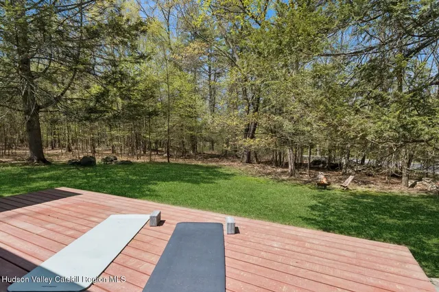 a view of a wooden floor and trees in the background