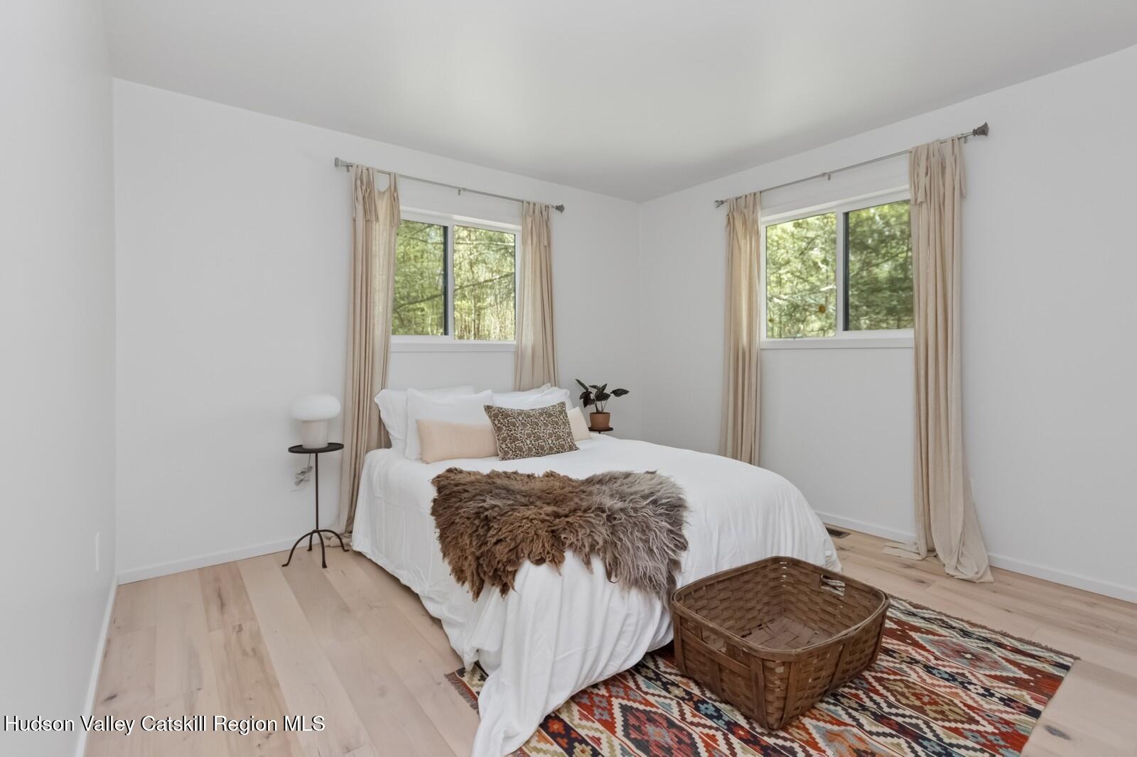 25 Upper Cherrytown Road Kerhonkson, NY 12446 - Photo 15 of 23 a bedroom with a bed and wooden floor