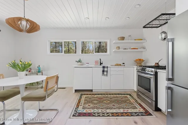 a kitchen with cabinets and chairs