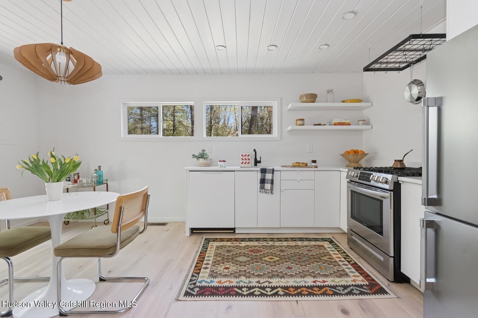25 Upper Cherrytown Road Kerhonkson, NY 12446 - Photo 2 of 23 a kitchen with cabinets and chairs