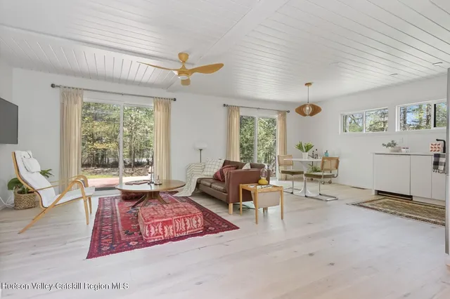 a living room with furniture a window and a table