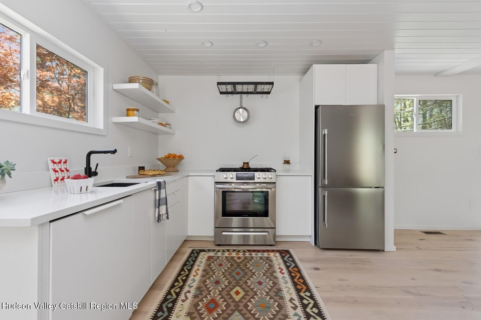 25 Upper Cherrytown Road Kerhonkson, NY 12446 - Photo 5 of 23 a kitchen with a refrigerator and a sink