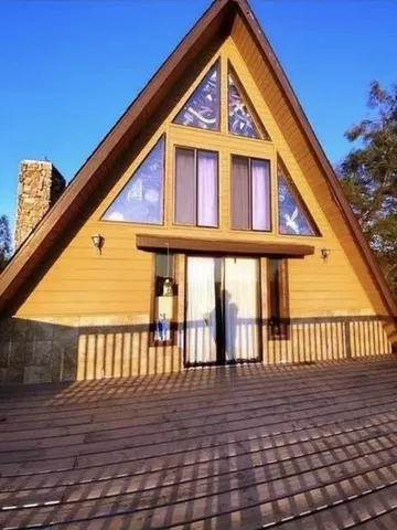 a view of front of house with a deck