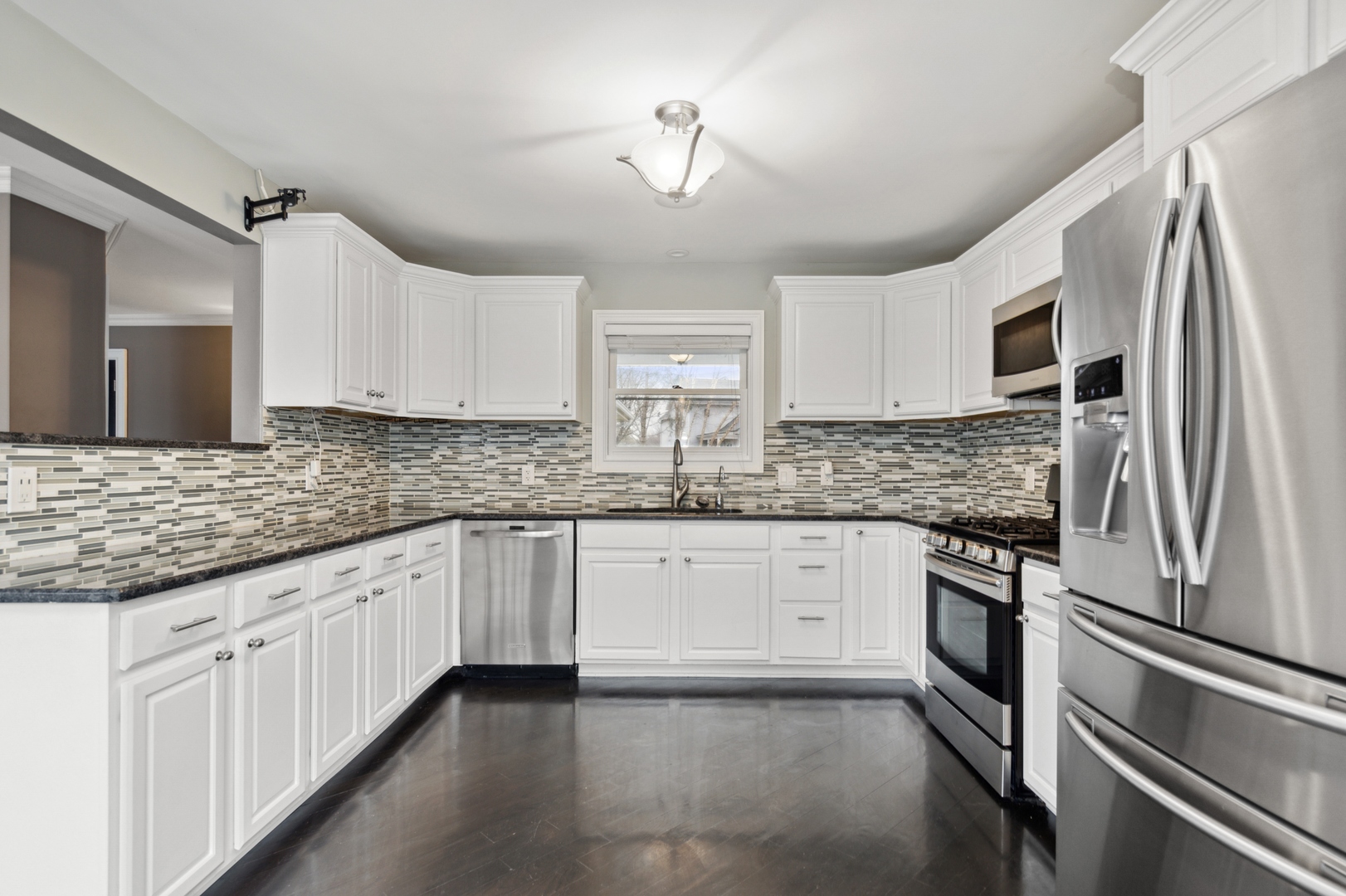1000 Hollywood Boulevard McHenry, IL 60050 - Photo 5 of 16 a kitchen with granite countertop a sink stainless steel appliances and cabinets
