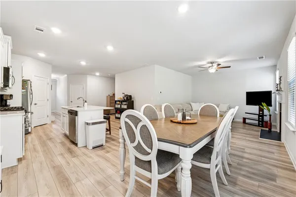 a view of a dining room with furniture and wooden floor