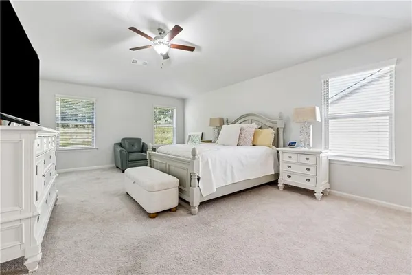 a bedroom with furniture and a flat screen tv