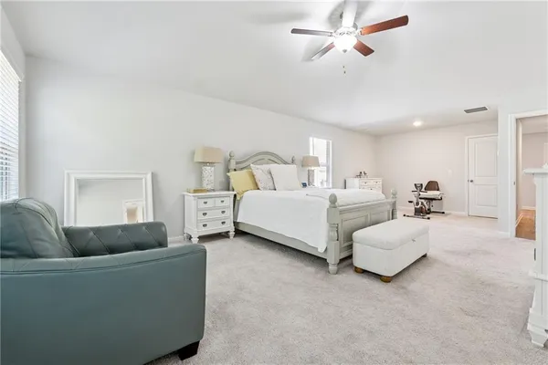 a living room with furniture and a ceiling fan