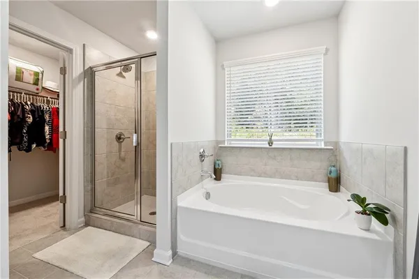 a white bath tub sitting next to a shower