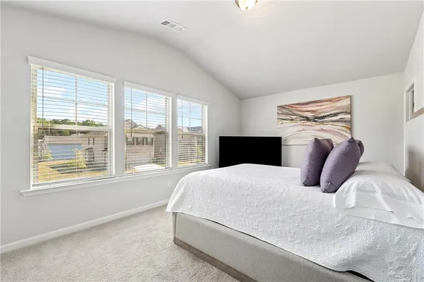 a bedroom with a large bed and a large window