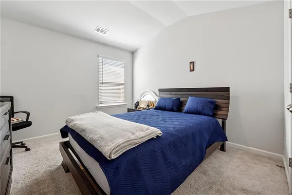a bedroom with a bed and a table in it