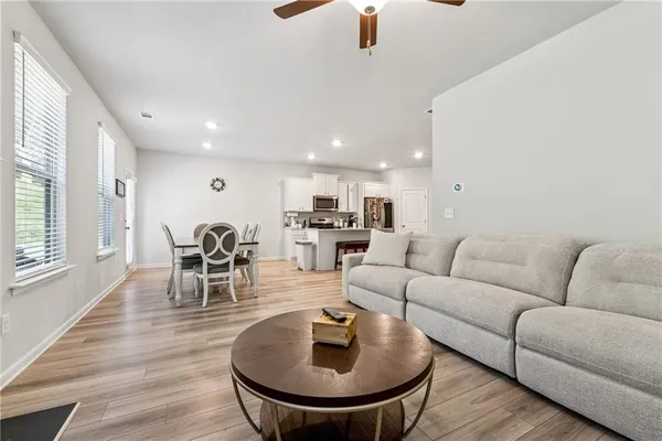 a living room with furniture and kitchen view